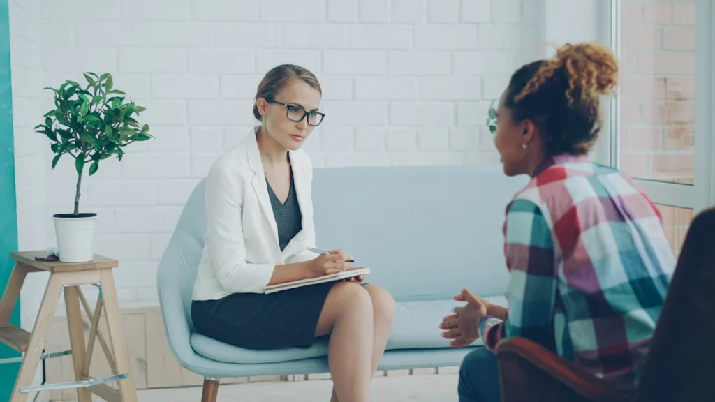 Two women in conversation during a therapy consultation, representing the first step in getting NDIS occupational therapy started